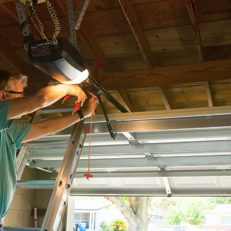 man-repairing-garage-door Man Repairing Garage Door